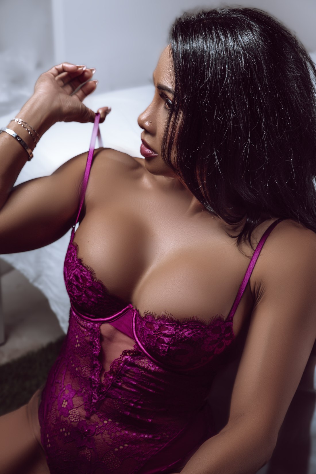 An elegant boudoir portrait in burgundy lingerie, photographed by True Romance Boudoir